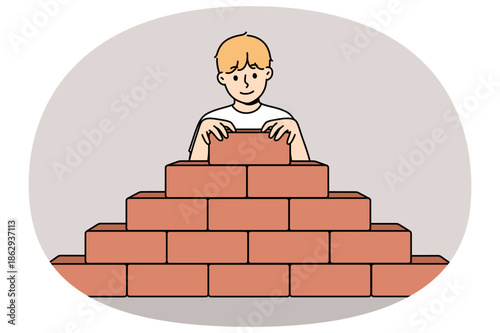 Little boy builds pyramid bricks, wanting to become builder and enroll in architectural university. Child builds sustainable structure, demonstrating architectural and engineering skills