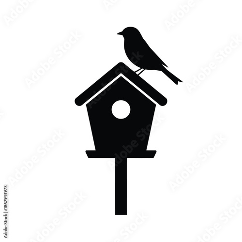 A simple black silhouette of a bird perched on a birdhouse