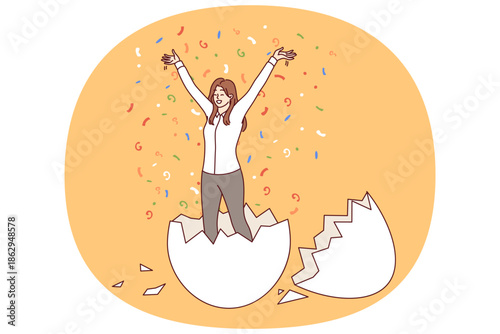 Business woman hatched from egg raises hands up, for concept of birth of new professional. Business triumph of successful businesswoman standing among confetti and rejoicing at revival