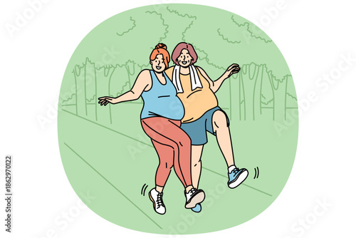 Two bigsize women run through park, doing sports to lose weight and improve well-being. Morning run bigsize girlfriends struggling with problem of obesity, enjoying healthy lifestyle and good weather