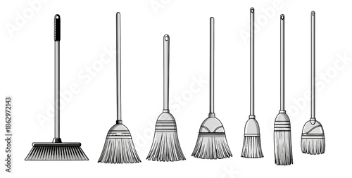A collection of various brooms and brushes of different sizes and styles, arranged in a line.