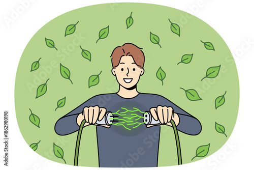 Man uses green energy obtained from environmentally friendly or alternative sources and connects two wires. Guy rejoices at receiving regenerative green energy to reduce co2 emissions
