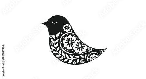 Silhouette of a black bird decorated with intricate white floral patterns and leaf designs in a traditional folk art style.