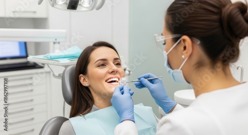 Woman in dental chair, having a teeth examination, in modern clinic setting. Dentist examining patient's teeth.