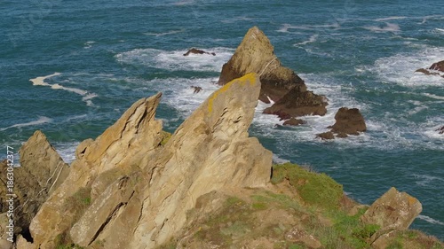 Jagged Rock Pillars Emerging From The Waters At The Coastline Near Loiba, A Coruña In Galicia, Spain. Aerial Drone Shot