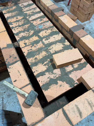 Fresh brickwork of a heating stove bench. Overlap of the benchs smoke channels.