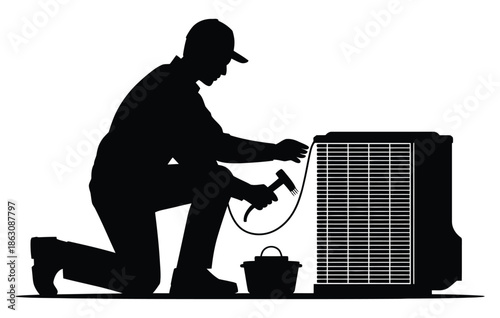 HVAC technician silhouette kneels performing maintenance on an outdoor air.