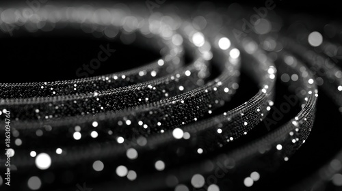 Abstract grayscale image featuring swirling, glowing lines against a dark background