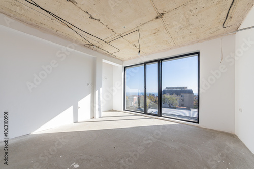 New empty room under construction. New home. Concrete walls. Interior renovation.