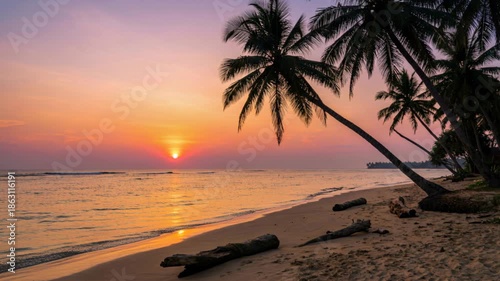 Vibrant Orange Sunset Over Tropical Beach With Silhouetted Palm Trees and Gentle Waves Reflecting Golden Light on the Sand
