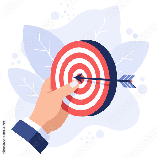 Hand holding a bullseye target with arrow in center for accuracy and precision concept