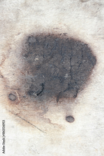 Wood Texture Stain: An abstract and evocative close-up shot of a wood surface, stained with a dark, enigmatic mark, evoking a sense of history, mystery and raw texture.