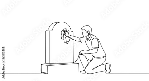 Man cleaning gravestone while kneeling in a cemetery  