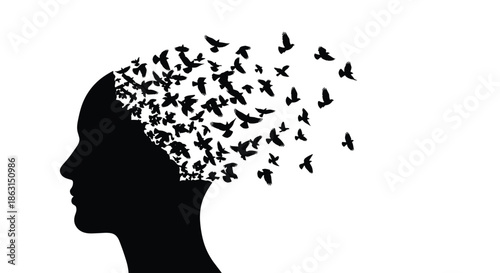 Conceptual silhouette of a human head with a flock of birds flying out from the mind representing freedom and creative imagination.