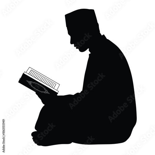 Silhouette of a man reading the holy quran