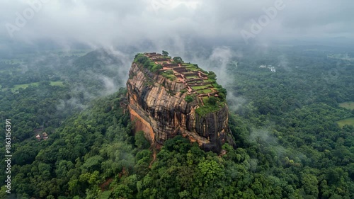 Misty Morning Aerial View of Ancient Sigiriya Rock Fortress and Lush Green Jungle Landscape in Sri Lanka