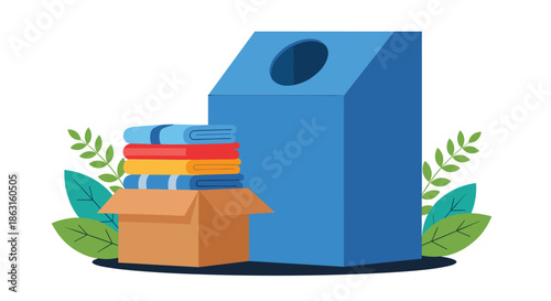 Blue clothing donation bin next to a cardboard box filled with neatly folded colorful clothes and green plant leaves for charity.