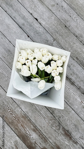 of white tulips in a white box.