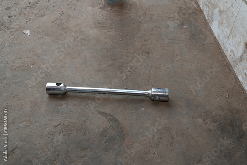 Chrome Lug Wrench on Concrete Floor