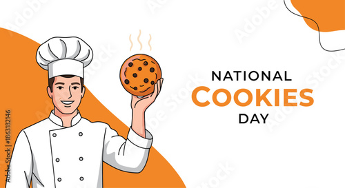 Smiling professional male chef in white uniform holds up a freshly baked chocolate chip cookie during the National Cookies Day celebration.