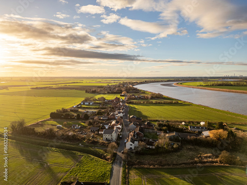 Aerial view of the village of Whitgift in East Riding of Yorkshire, England, surrounded by farmland and countryside near the River Ouse under evening light.