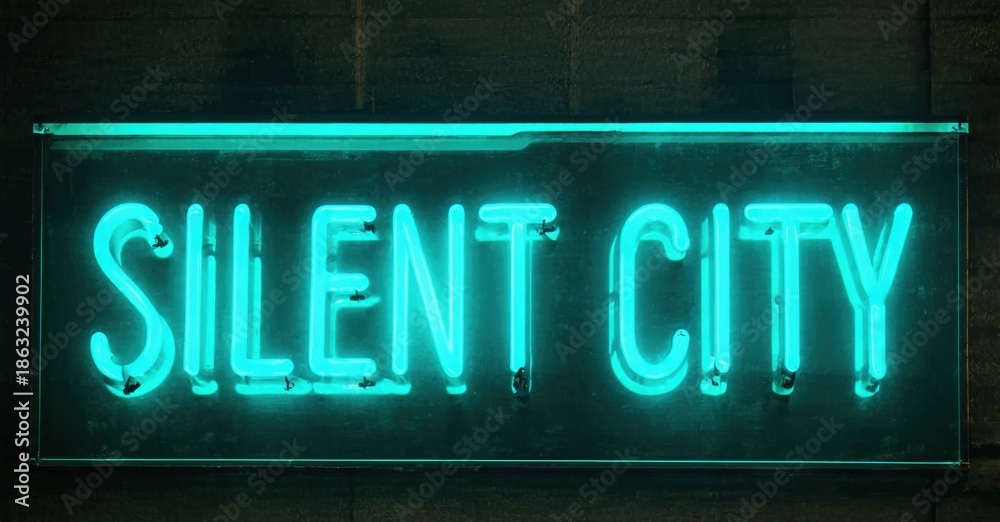 Fototapeta premium Bright neon sign displays Silent City. Dark background emphasizes glowing turquoise lettering. Minimalist aesthetic, urban setting.
