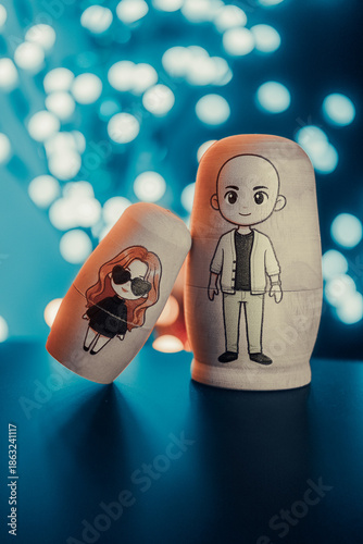 Custom made Nesting dolls (matryoshka) in front of blue bokeh background