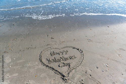 A heart is drawn in the sand on a beach