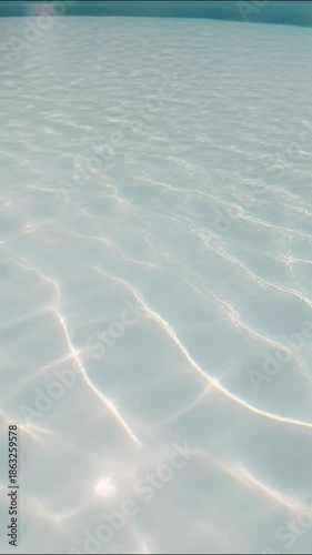 A tranquil image captures the pure, inviting surface of a swimming pool. The crystal-clear water sparkles and dances, reflecting light and creating a sense of serenity.