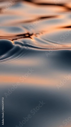 Abstract image of water ripples reflecting sunset colors, creating a serene and captivating scene. The water surface gently moving, creating a play of light and shadow