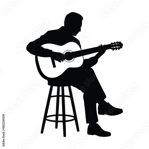 A silhouetted musician playing an acoustic guitar while seated on a stool