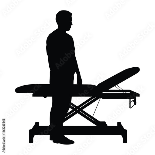Silhouette of a man standing near a medical examination table