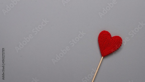 Red Heart Shape on a Wooden Stick on a Gray Background