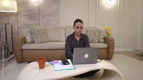 Young woman freelancer working remotely from home office