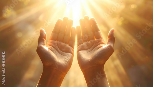 Two hands held open and upwards towards a bright glowing light representing hope and spiritual connection