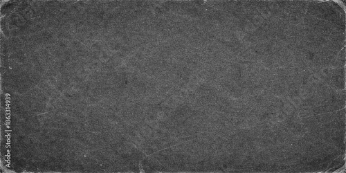 A dark grunge wallpaper design featuring a seamless blend of black leather material, rough asphalt stone surface, and vintage grey textured paper for an old textile backdrop structure