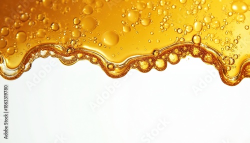 Golden cannabis wax resin drips with air bubbles. Sticky concentrate detail isolated on white background. Organic extract macro view for medical or recreational use.