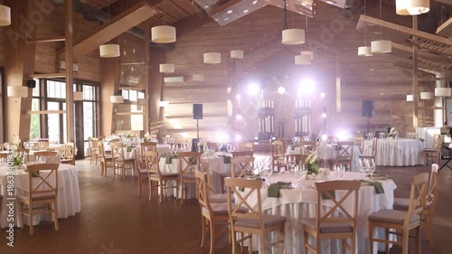 Decorated round white tables inside on a wedding