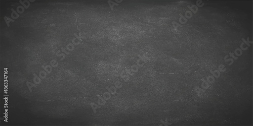 Blank vintage black chalkboard background with a dark gray grunge texture on a rough stone concrete wall surface for a textured design backdrop