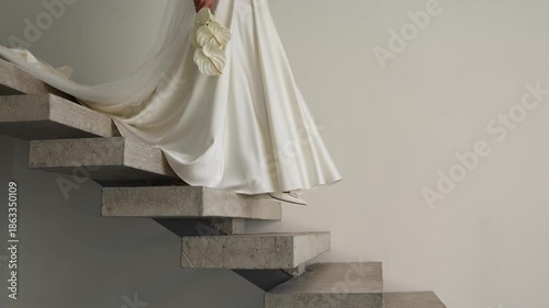 Bride going down the stairs in a white dress