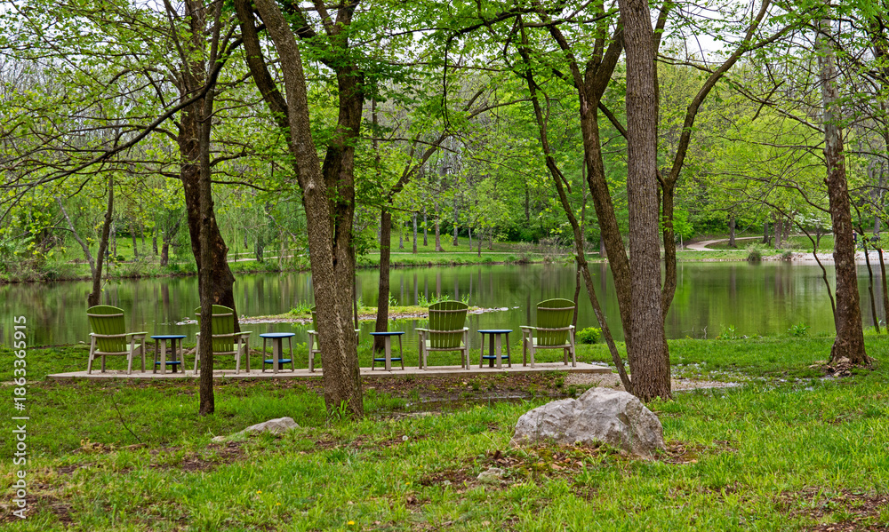 Obraz premium Green lawn chairs facing water