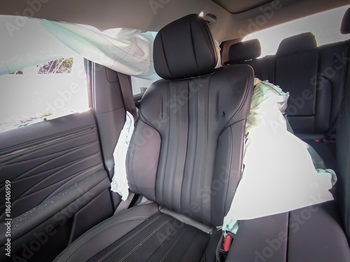 Interior view of a modern vehicle showing deployed side curtain and seat airbags after a car accident. The image highlights vehicle safety features, impact protection, and the aftermath of a road coll