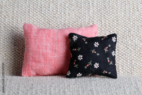Pink and black cushions with floral pattern on sofa