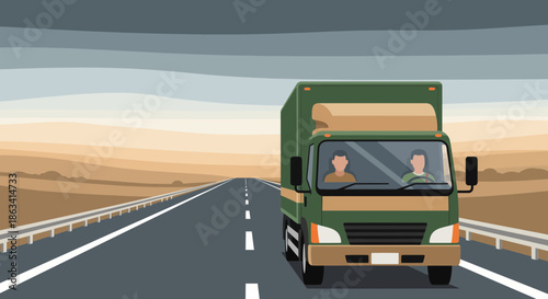 Green delivery truck driving on a long road with two people inside the cabin.