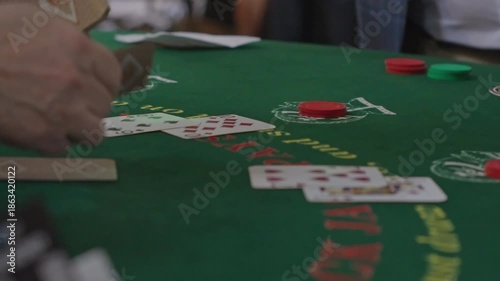 Dealer Dealing Blackjack Cards Across Casino Table