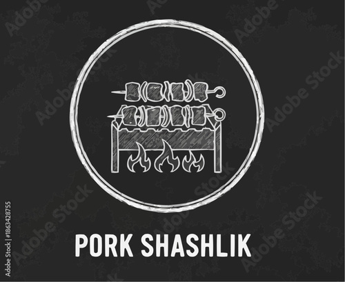 Pork shashlik grilling over flames on a chalkboard background
