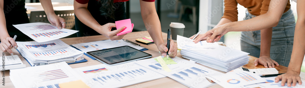 © NAMPIX - Collaborative business team analyzing financial data charts and statistics on office desk during a productive meeting. © NAMPIX - Collaborative business team analyzing financial data charts and statistics on office desk during a productive meeting.