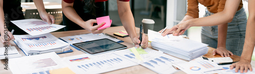 Photos Collaborative business team analyzing financial data charts and statistics on office desk during a productive meeting