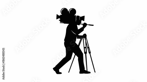 Silhouette of a cameraman carrying a vintage film camera on his shoulder.