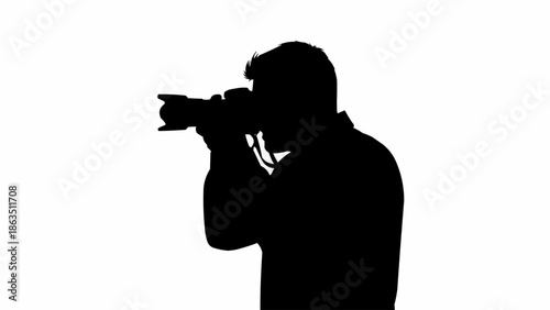 Silhouette of a photographer holding a professional camera and taking a photo.